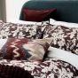 Aris Ikat Bolster Cushion by Bedeck of Belfast in Mulberry Red